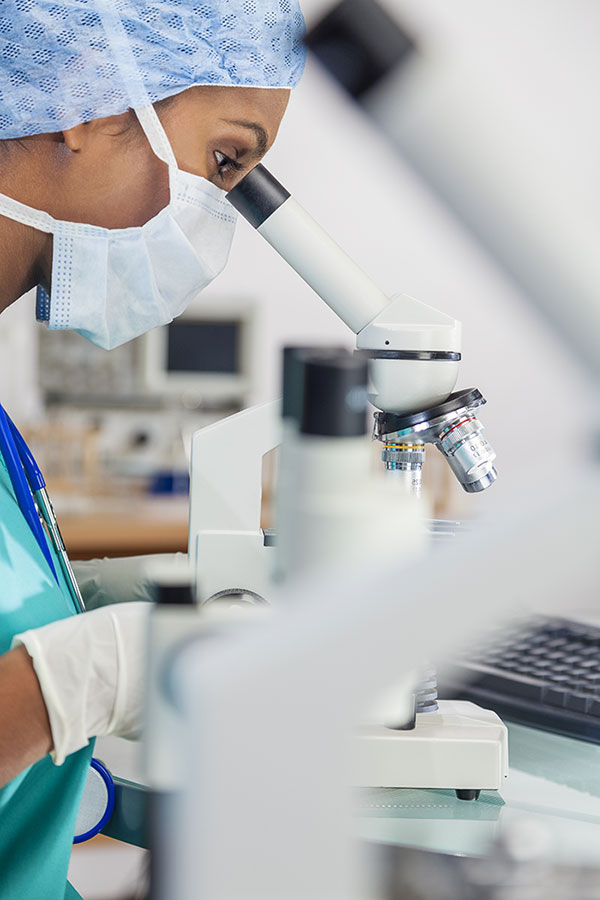 Lab Technician Using Microscope