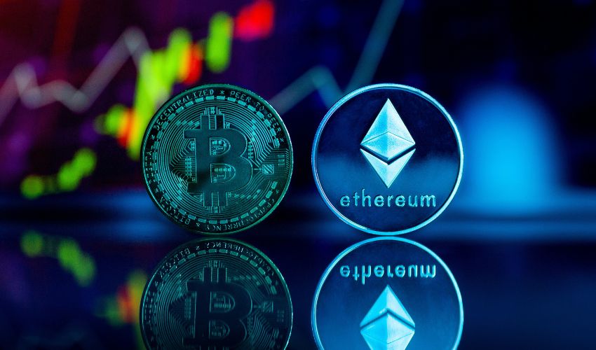 A digitally-created image visualises Bitcoin and Ethereum cryptocurrencies as holographic coins with the stock market in the background