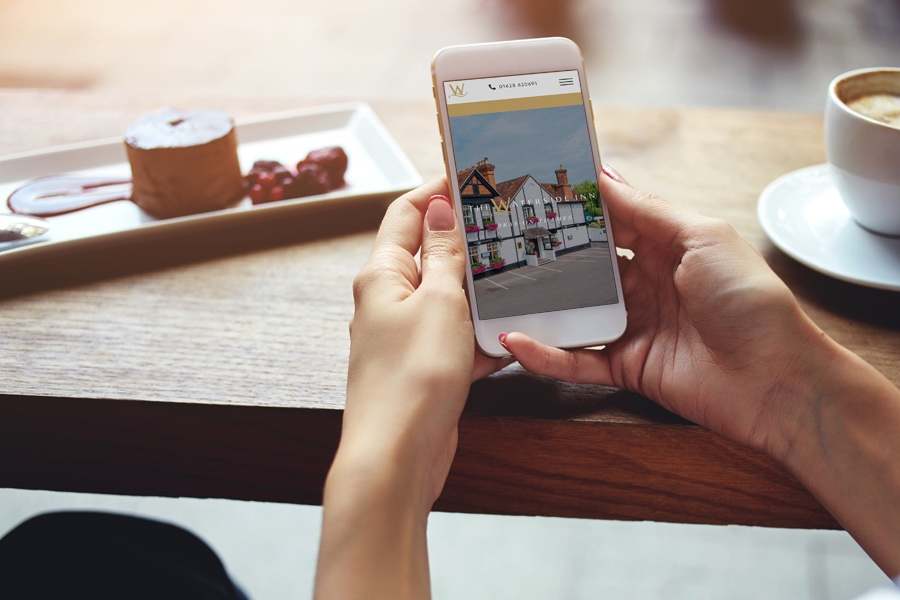 A chef browses their website on a mobile phone