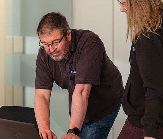 Standing viewing a laptop